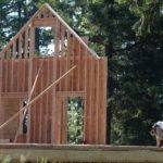THE SLUMP in U.S. residential construction continued in July, as housing starts and building permits both hit 10-year lows. Above, carpenter Jesse Kennedy uses a nail gun as he frames a new house in Eugene, Ore. / 