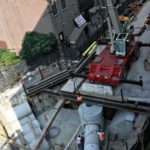 GOVERNMENT SPENDING and commercial construction both helped boost the July GDP. Above, workers with Judlau Contracting fit cement piping for an MTA project at Rockwell Place in Brooklyn, N.Y. / 