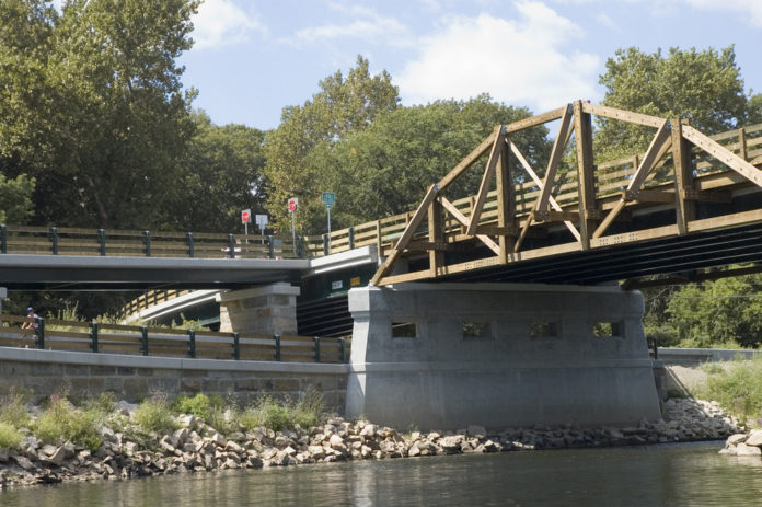 It took three years and $9 million, but last week vehicular, bicycle and pedestrian traffic was once again allowed to travel back and forth from Lincoln to Cumberland, and up and down the Blackstone River, on the newly reconstructed Martin Street and Berkeley bridges. Federal and state officials were on hand last week  to open the new byways. / PBN photo/Jaime Lowe