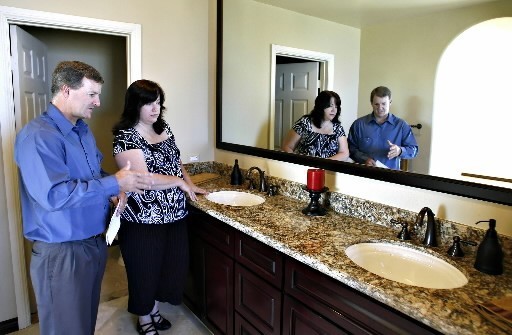 MORTGAGE ISSUES and buyer fears drove down existing home sales in August, the NAR said. In Crest, Calif., this weekend, Realtor Todd Mitchell tours a house with prospective buyer Tonya Burgess. / MORTGAGE ISSUES and buyer fears drove down existing home sales in August, the NAR said. In Crest, Calif., this weekend, Realtor Todd Mitchell tours a house with prospective buyer Tonya Burgess. /