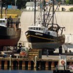 AT PROMET MARINE, a worker is dwarfed by vessels at the yard. The company is one of several along the waterfront that are concerned about proposed zoning changes. / 