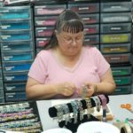 BELINDA BATON, a 33-year employee of Hope Valley-based Greene Plastics Corp., works on a Victorian Lace bracelet that is one of several new products. After decades of catering to the wholesale trade, the firm has begun selling more items directly to consumers. / 