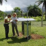 ALEXIS WALKER, left, and Catherine Rychert, both Brown students, install a seismic station near the Miravalles volcano in Costa Rica. / 