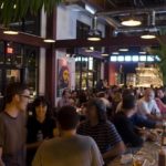 PATRONS GATHER at the bar of the new Cuban Revolution restaurant, which opened Oct. 5 in a 4,200-square-foot space at The Plant in Olneyville. / 
