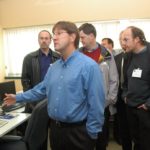 URI hosts international jet research conference MICHAEL PLATEK, an electrical engineer at URI, shows a group of scientists and engineers around the lab of the school’s Surface and Sensors Technology Partnership. /