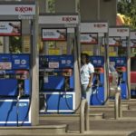 THE AVERAGE U.S. PRICE for self-service regular unleaded rose 12 cents to $3.019 per gallon, 6 cents more than in Rhode Island, AAA found. Above, a customer examines the pump at an Exxon in Columbus, Ohio. / 