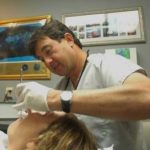 DR. GUS NOGUEIRA, owner and chief practitioner at Aquidneck Dental Associates in Portsmouth, says patients are increasingly seeking cosmetic procedures to keep their smiles youthful as they age. Above, he treats Cheryl Borbone. / 