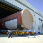 Defense spending bill includes $49M for R.I. ELECTRIC BOAT is slated to receive $588 million under the 2008 defense appropriations bill. Above, the middle section of the North Carolina, to be commissioned next May, is moved out of a building shed at Quonset Point on its way to Groton. /