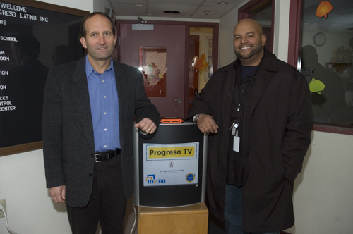 <b>ENTREPRENEUR</b> John Zib, left, shows off one of his electronic displays at Progreso Latino in Central Falls. With him is George Ortiz, chief operating officer of the nonprofit. / <b>ENTREPRENEUR</b> John Zib, left, shows off one of his electronic displays at Progreso Latino in Central Falls. With him is George Ortiz, chief operating officer of the nonprofit. /