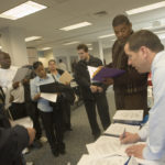 NORTH ATTLEBORO Postmaster Michael Anderson, right, speaks with job-seekers at a Veterans&rsquo; Jobs Fair at netWORKri last week. / 