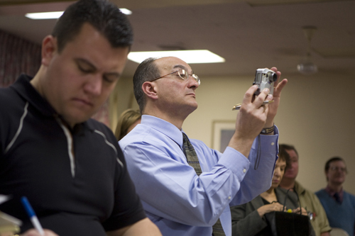 <b>PAUL PALANGE,</b> publisher of the Senior Digest, does almost everything, from reporting and taking photographs, to selling ads, to even making deliveries. Above, he covers a press conference on Meals on Wheels budget cuts. / <b>PAUL PALANGE,</b> publisher of the Senior Digest, does almost everything, from reporting and taking photographs, to selling ads, to even making deliveries. Above, he covers a press conference on Meals on Wheels budget cuts. /
