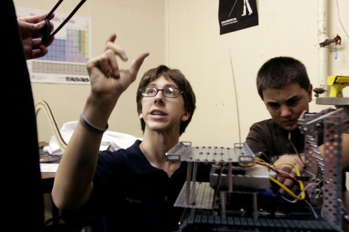 CARL CROFT, a junior at New England Laborers&rsquo; Cranston Public School Construction Career Academy, and sophomore Michael Sisto build a prototype robot for the upcoming FIRST Tech Challenge. / 