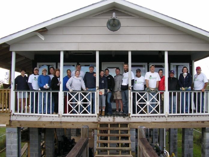 SHAWMUT EMPLOYEES joined local volunteers rebuilding a house in Mississippi. Left to right by the third pillar, Ed Sherlock, construction manager; Kristen Woodbury, project administrator assistant; and Meredith Pfaff, business development coordinator. / SHAWMUT EMPLOYEES joined local volunteers rebuilding a house in Mississippi. Left to right by the third pillar, Ed Sherlock, construction manager; Kristen Woodbury, project administrator assistant; and Meredith Pfaff, business development coordinator. /