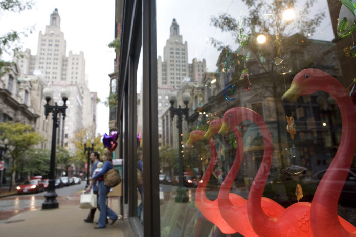 BRIGHT FLAMINGOS provide a splash of nonsectarian holiday color in the window of one downcity storefront. / BRIGHT FLAMINGOS provide a splash of nonsectarian holiday color in the window of one downcity storefront. /