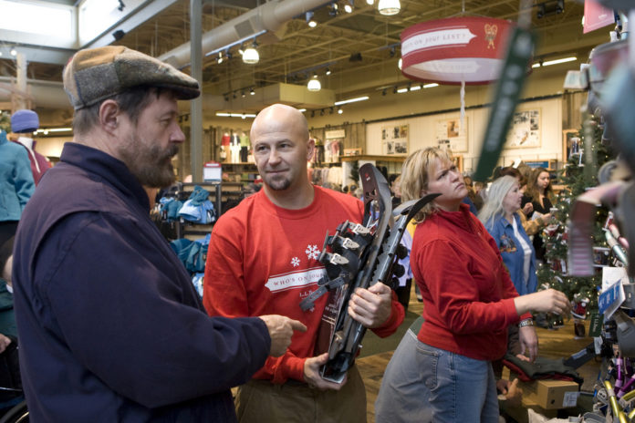 L.L. BEAN EMPLOYEE Scott Mighill shows customer Bob Fredrick a set of showshoes during opening day of the 25,000-square-foot store in Mansfield Nov. 16. / L.L. BEAN EMPLOYEE Scott Mighill shows customer Bob Fredrick a set of showshoes during opening day of the 25,000-square-foot store in Mansfield Nov. 16. /