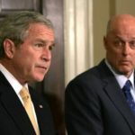 HENRY PAULSON, right, secretary of the Treasury, looks on as President George W. Bush makes his statement today in the Roosevelt Room at the White House, where they and other officials announced an agreement by lenders to freeze rates on some subprime ARMs for five years, to stem the rising tide of foreclosures. / 