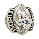 JOSTENS DESIGNED and manufactured this ring for the New England Patriots, to commemorate their SuperBowl XXXIX triumph, and also has crafted championship rings for the Boston Red Sox. / 