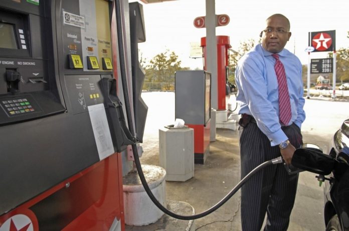 CONTINUING HIGH PRICES at the fuel pump are helping lower the level of consumer sentiment, and thus constraining their willingness to spend and support the economy. Above, motorist Chris Smith fuels his vehicle at a Texaco station in Atlanta. / 