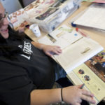 Jessica Lawson, an expectant mother, scans magazines to find images to use to build a collage, part of therapy that Women & Infants Hospital in Providence has been integrating into prepartum and postpartum sessions to help patients deal with issues they may have difficulty expressing verbally. PBN subscribers can read the full story here. / 