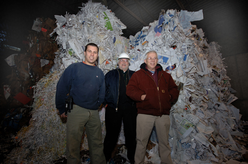 SORTING THROUGH THE JUNK: From left, Adam, Sam and Charlie Sinel of Berger & Co. Recycling Inc. stand near a pile of materials slated to be recycled. The company today buys recyclables and sells them on the global commodities market. / SORTING THROUGH THE JUNK: From left, Adam, Sam and Charlie Sinel of Berger & Co. Recycling Inc. stand near a pile of materials slated to be recycled. The company today buys recyclables and sells them on the global commodities market. /