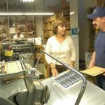 Grant-writing functions reach beyond HR staff NAMEPLATES FOR INDUSTRY received a portion of a work force investment grant for training. Above, Vice President Marcia LaBelle talks to die-cutter Gil Vieria at the New Bedford plant. /