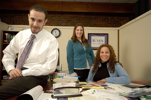 FINEES MENDEZ, left, was a founder of RI Marketing & Advertising in 2001. Above, he is pictured with Elisha Hicks, center, the firm’s graphic design director, and General Manager Priscilla Collado. / PBN PHOTO/BRIAN MCDONALD FINEES MENDEZ, left, was a founder of RI Marketing & Advertising in 2001. Above, he is pictured with Elisha Hicks, center, the firm’s graphic design director, and General Manager Priscilla Collado. / PBN PHOTO/BRIAN MCDONALD