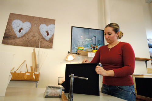 LAURA PARENTEAU, an employee at Portfoliobox Inc. in Pawtucket, laminates fabric to a tray that will fit into a box when finished. The company’s clients range from artists looking for portfolio boxes to corporate clients looking to make an impression. / LAURA PARENTEAU, an employee at Portfoliobox Inc. in Pawtucket, laminates fabric to a tray that will fit into a box when finished. The company’s clients range from artists looking for portfolio boxes to corporate clients looking to make an impression. /