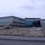 THE BUILDING constructed by the former Brooks Pharmacy to serve as its headquarters, above, is part of the 25-acre parcel purchased from Rite Aid today by New England Institute of Technology. / 