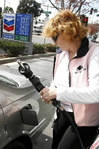 NATIONWIDE, the average price of self-serve regular fell 3 cents this week to $2.989 per gallon, while the Ocean State average fell 3 cents to $3.049. Above, Judy Smith pumps gas earlier this month at a Chevron station in La Mesa, Calif. / NATIONWIDE, the average price of self-serve regular fell 3 cents this week to $2.989 per gallon, while the Ocean State average fell 3 cents to $3.049. Above, Judy Smith pumps gas earlier this month at a Chevron station in La Mesa, Calif. /
