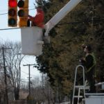 EPA asks N.E. communities to pay now to save later A CITY WORKER IN Warwick replaces old incandescent bulbs in traffic lights with energy efficient LED bulbs to meet standards set by an EPA challenge. /