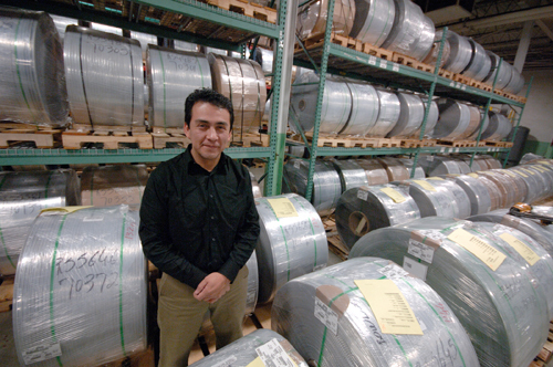 JESUS AGUILAR stands among finished wire products at Hope Global of Cumberland, in the department where he is manufacturing supervisor. A Guatemalan immigrant, he arrived in the U.S. with little education but now has advanced computer skills. / JESUS AGUILAR stands among finished wire products at Hope Global of Cumberland, in the department where he is manufacturing supervisor. A Guatemalan immigrant, he arrived in the U.S. with little education but now has advanced computer skills. /