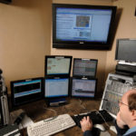 SMITHFIELD FIRE DEPARTMENT dispatcher Stephen Keene views the enhanced communication system set up with the help of Bryant University. / 