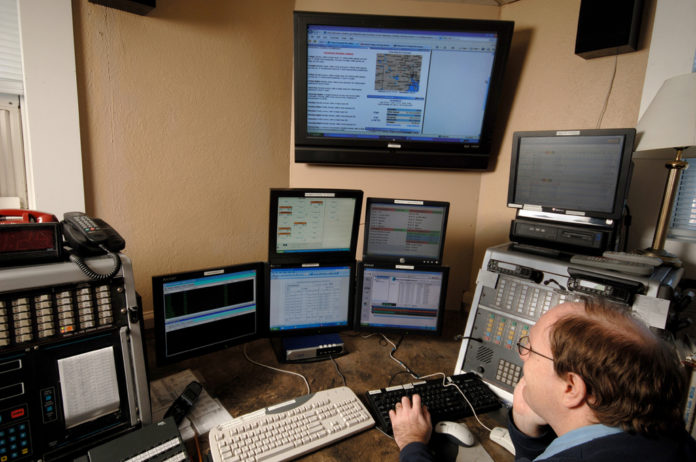 SMITHFIELD FIRE DEPARTMENT dispatcher Stephen Keene views the enhanced communication system set up with the help of Bryant University. / SMITHFIELD FIRE DEPARTMENT dispatcher Stephen Keene views the enhanced communication system set up with the help of Bryant University. /