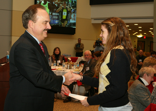 Larry Merlo, executive vice president of CVS Caremark Corporation and president of CVS/pharmacy, presents a check to Jeanne Mack, a senior at LaSalle Academy who participated in the Downtown 5K as both a volunteer and a runner. She accepted the check on behalf of the LaSalle Academy girls track club. / Larry Merlo, executive vice president of CVS Caremark Corporation and president of CVS/pharmacy, presents a check to Jeanne Mack, a senior at LaSalle Academy who participated in the Downtown 5K as both a volunteer and a runner. She accepted the check on behalf of the LaSalle Academy girls track club. /