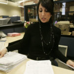 A business-friendly way to file with government DENISE SEPE, an administrative assistant at the R.I. Secretary of State’s office, sorts through annual reports last week that were mailed in by for-profit busineeses. / PBN PHOTO/MATTHEW HEALEY