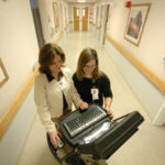 ROGER WILLIAMS MEDICAL CENTER Nursing Manager Darlene Kershaw, left, and Gina Andrioli, a certified nursing assistant, confer over a mobile EMR computer. / 