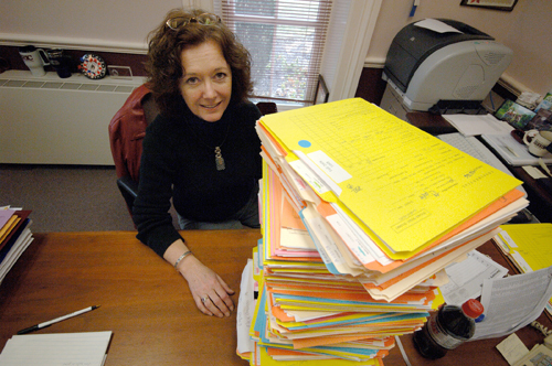 HOLLY SHADOIAN, director of admissions
at Rhode Island College, sits behind a stack
of applications. Most schools in the state have witnessed a spike in applications. / HOLLY SHADOIAN, director of admissions
at Rhode Island College, sits behind a stack
of applications. Most schools in the state have witnessed a spike in applications. /