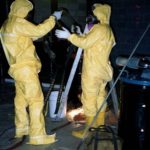 Cleaning up a very dirty occupation MARSHALL ENVIRONMENTAL workers remove contaminated soil and grit from an industrial site in Pawtucket. The Warwick-based company does work throughout the Northeast. /