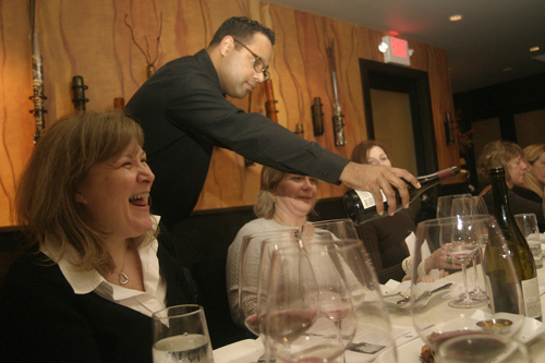 PAULO RAMOS serves Patty Carbone, left, and Kim Maine at Eleven Forty Nine Restaurant’s “Wine Divas” night, one of the events the new restaurant is looking to use to offer patrons more of an experience. / PAULO RAMOS serves Patty Carbone, left, and Kim Maine at Eleven Forty Nine Restaurant’s “Wine Divas” night, one of the events the new restaurant is looking to use to offer patrons more of an experience. /