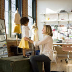 ELLIE, a 4-year-old model, waits as Sarah Waldo makes adjustments on a sunshine-
yellow hemp and silk skirt called &ldquo;The Indie&rdquo; from Waldo&rsquo;s organic clothing line. / 