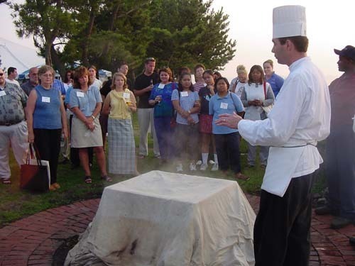 MEETING PLANNERS listen to an explanation by the chef at the Hyatt Regency on how a lobster bake is prepared. / MEETING PLANNERS listen to an explanation by the chef at the Hyatt Regency on how a lobster bake is prepared. /