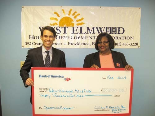 WILLIAM F. HATFIELD, Rhode Island president of Bank of America, presents a check for $30,000 to Sharon Conard-Wells, executive director of West Elmwood Housing Development Corporation. / WILLIAM F. HATFIELD, Rhode Island president of Bank of America, presents a check for $30,000 to Sharon Conard-Wells, executive director of West Elmwood Housing Development Corporation. /