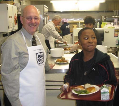 NEW ENGLAND GAS COO David Black serves a meal to Thomas Chew Memorial Boys & Girls Club Café patron, Stephon Calise. / NEW ENGLAND GAS COO David Black serves a meal to Thomas Chew Memorial Boys & Girls Club Café patron, Stephon Calise. /