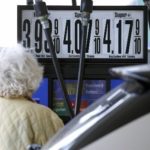 GASOLINE, crude oil and heating oil prices soared after a government report last week showed U.S. supplies are down. Above, a woman gazes at the prices atop a pump in New York. / 