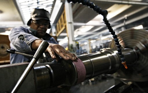 RAW MATERIALS and energy costs are squeezing companies that find it difficult to pass increases on to customers in the current economy. Above, Chimtomby Ramar uses a lathe to smooth a custom replacement part at Titan Machine Corp., in Queens, N.Y., a maker of elevator components. / RAW MATERIALS and energy costs are squeezing companies that find it difficult to pass increases on to customers in the current economy. Above, Chimtomby Ramar uses a lathe to smooth a custom replacement part at Titan Machine Corp., in Queens, N.Y., a maker of elevator components. /