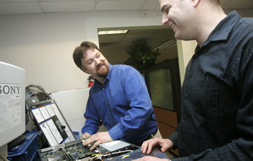TODD KNAPP, left, president of Envision Technology Advisors, said that his company is more of a business-consulting firm that
specializes in technology than a traditional IT firm. At right is Mike Ando, a virtualization specialist. / TODD KNAPP, left, president of Envision Technology Advisors, said that his company is more of a business-consulting firm that
specializes in technology than a traditional IT firm. At right is Mike Ando, a virtualization specialist. /