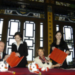 BRYANT UNIVERSITY President Ronald K. Machtley, left, and Preservation Society of Newport County CEO Trudy Coxe sign the new translation agreement in a May 2 ceremony at the ornate Chinese Tea House on the grounds of Marble House in Newport. / 