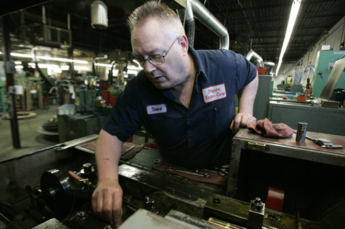 STEVE MAJOR adjusts a header machine at Pilgrim Screw’s factory in Providence. The company says that its business has grown in recent years, partially because of the weakened U.S. dollar. / STEVE MAJOR adjusts a header machine at Pilgrim Screw’s factory in Providence. The company says that its business has grown in recent years, partially because of the weakened U.S. dollar. /