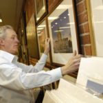 WORTH A THOUSAND WORDS: David O’Brien, owner of Picture This Framing Center & Gallery, hangs a photograph at the company’s new location in downtown Providence. O’Brien has an extensive background in marketing. / 