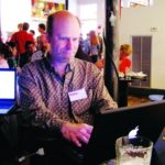 BRIAN JEPSON, a co-founder of the Providence Geeks, works on his laptop at a recent Geeks dinner at AS220. The monthly events now draw about 100 people each. / 
